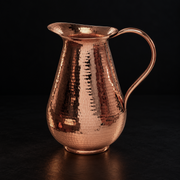 Elegant Bisotun hammered copper water pitcher with a glowing finish, perfect for sophisticated table serving.