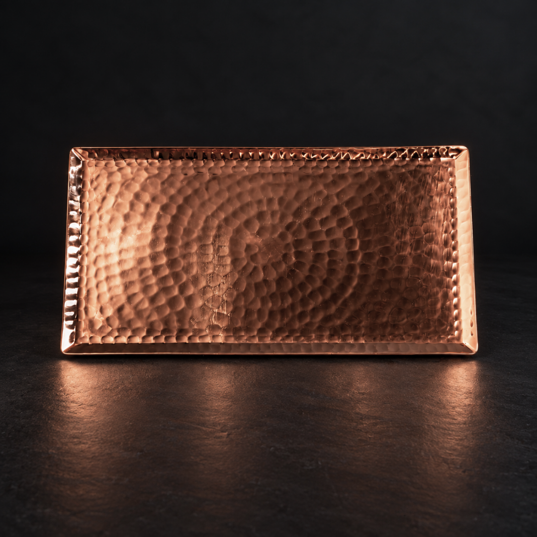 Elegant rectangular serving tray crafted from solid, hammered copper with a reflective, warm metallic finish.