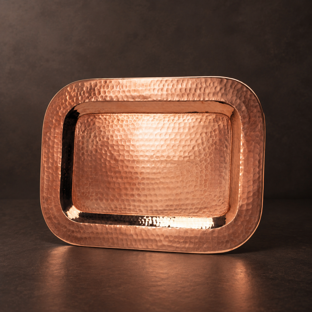 16x11-inch rectangular hammered copper platter with a polished finish and elegant rolled edges for serving or display.