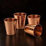 Set of four elegant, hammered solid copper shot cups with a durable, 2-inch wide-mouth design for spirits.