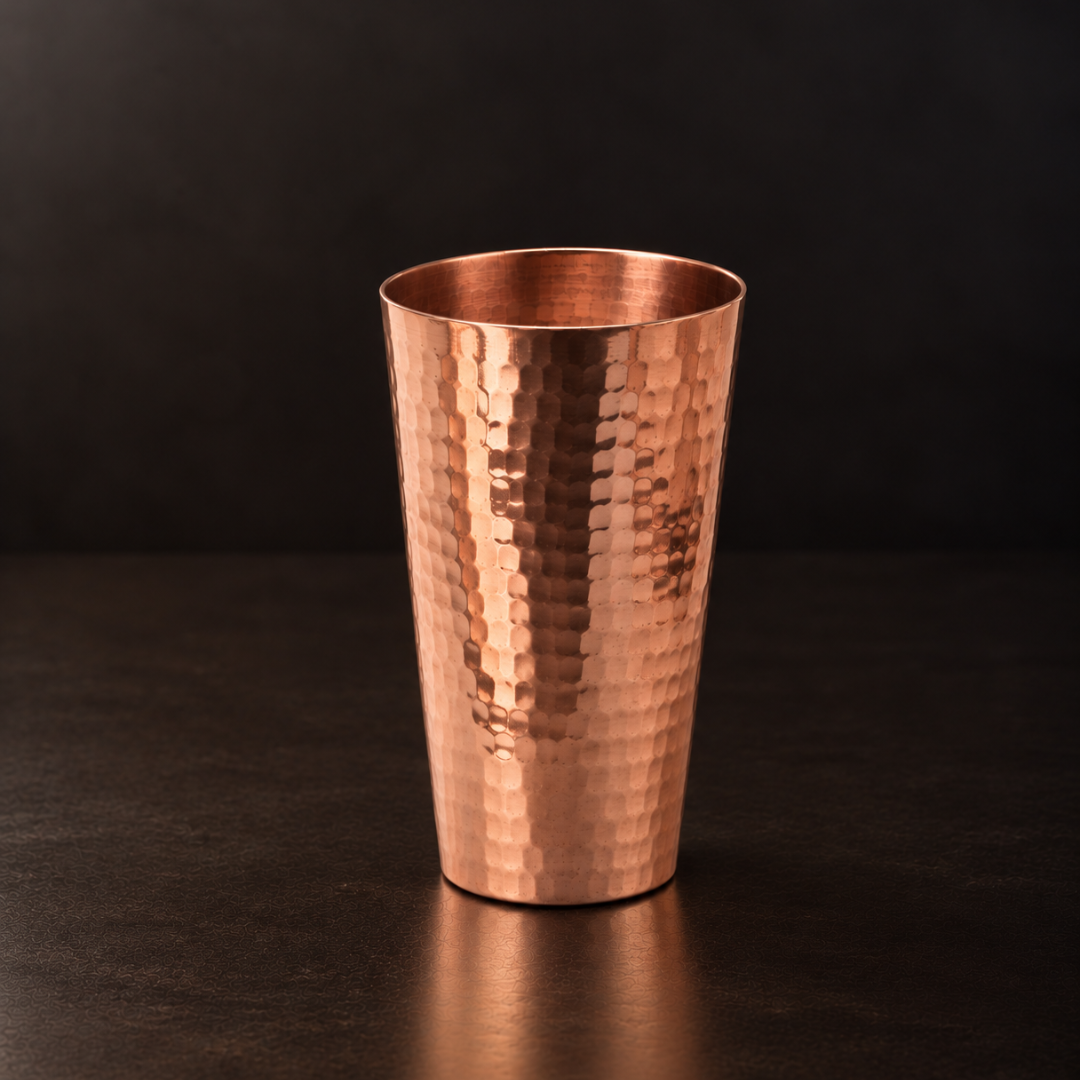 Tall, hand-hammered pure copper iced tea cup with a slender, elegant design for cold drinks and cocktails.