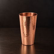 Tall, hand-hammered pure copper iced tea cup with a slender, elegant design for cold drinks and cocktails.
