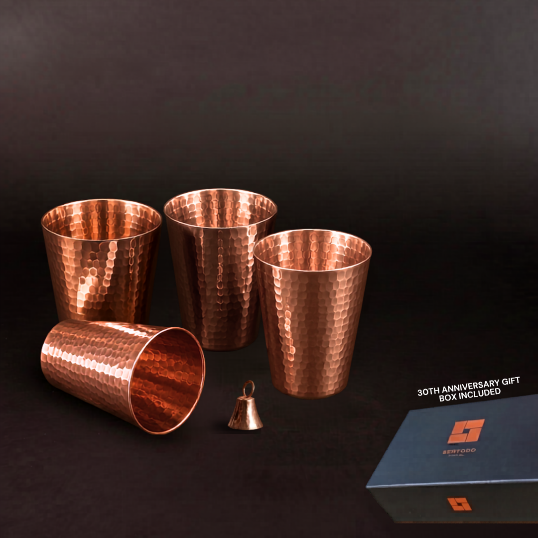 Four hand-hammered 10-ounce solid copper cups with a mantra bell and elegant gift box.