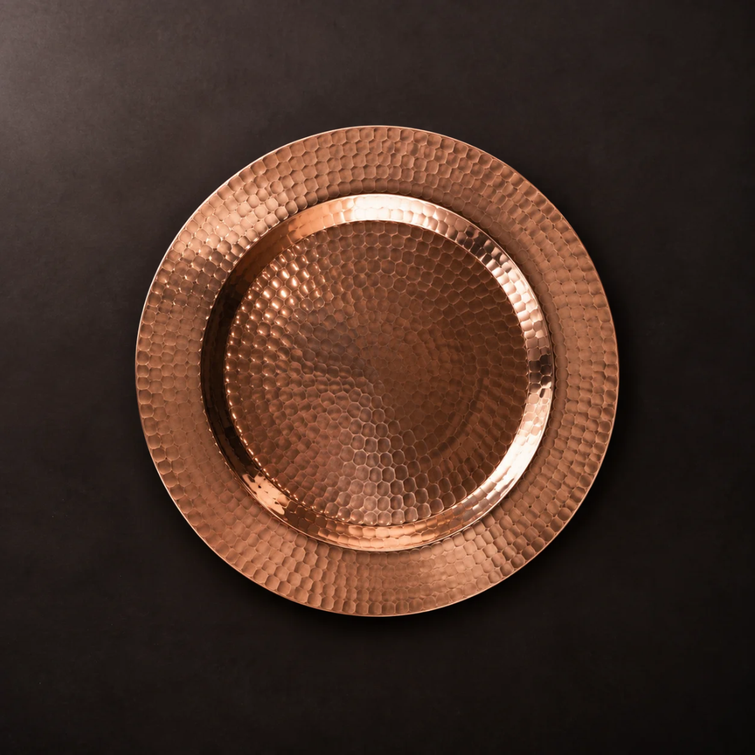 Thessaly 12-inch hammered copper charger plate with a warm metallic finish for elegant dining table settings.