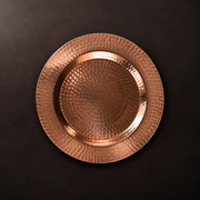 Thessaly 12-inch hammered copper charger plate with a warm metallic finish for elegant dining table settings.