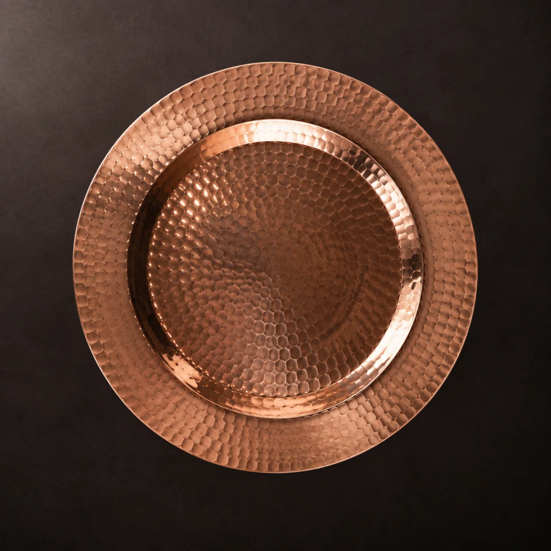 13-inch hammered copper charger plate with a polished finish, perfect for elegant table settings and event decor.