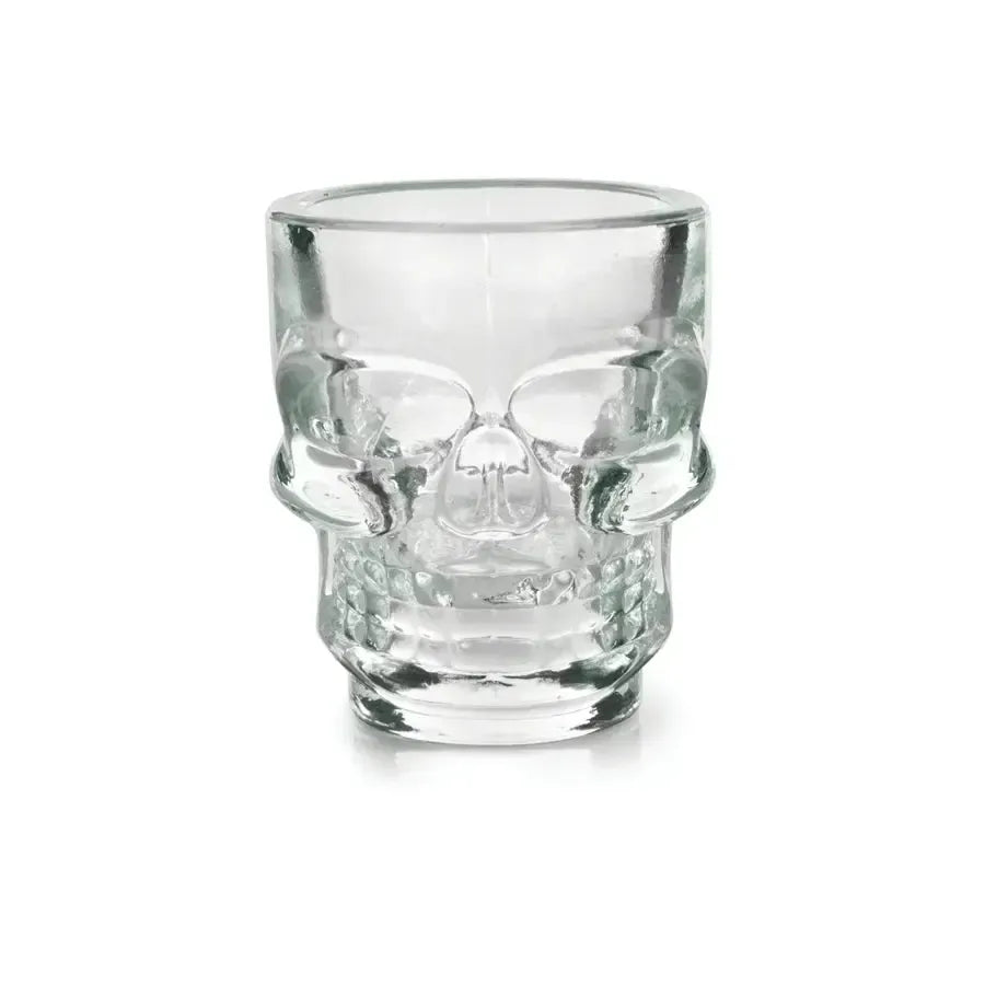 Clear glass 1.5 oz skull shot glass with detailed facial features, isolated on white.