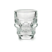 Clear glass 1.5 oz skull shot glass with detailed facial features, isolated on white.
