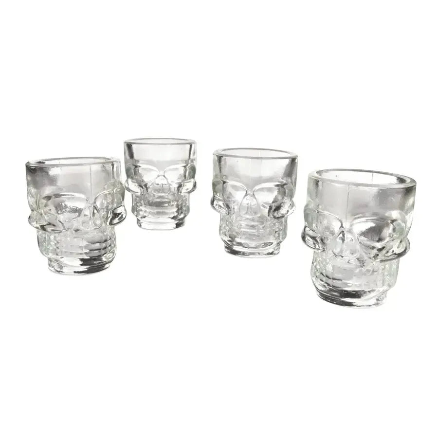 Set of 4 clear glass 1.5 oz skull-shaped shot glasses with detailed facial features.