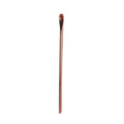 Handcrafted copper bar spoon with a gleaming finish, perfect for stirring cocktails.