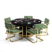 60" Prohibition Series poker table with matte black wood base, brass kick plate, and green chairs.