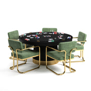 60" Prohibition Series poker table with matte black wood base, brass kick plate, and green chairs.