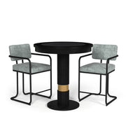 Black Prohibition Series pub table with textured laminate top and gold accent, flanked by two grey upholstered bar stools.