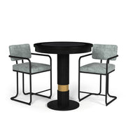Black Prohibition Series pub table with textured laminate top and gold accent, flanked by two grey upholstered bar stools.