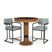Walnut Prohibition Series Pub Table with black laminate top, flanked by two gray upholstered bar stools.