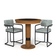 Walnut Prohibition Series Pub Table with black laminate top, flanked by two gray upholstered bar stools.