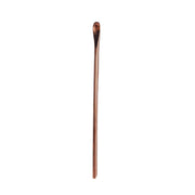 Handcrafted copper bar spoon with a gleaming finish, perfect for stirring cocktails.