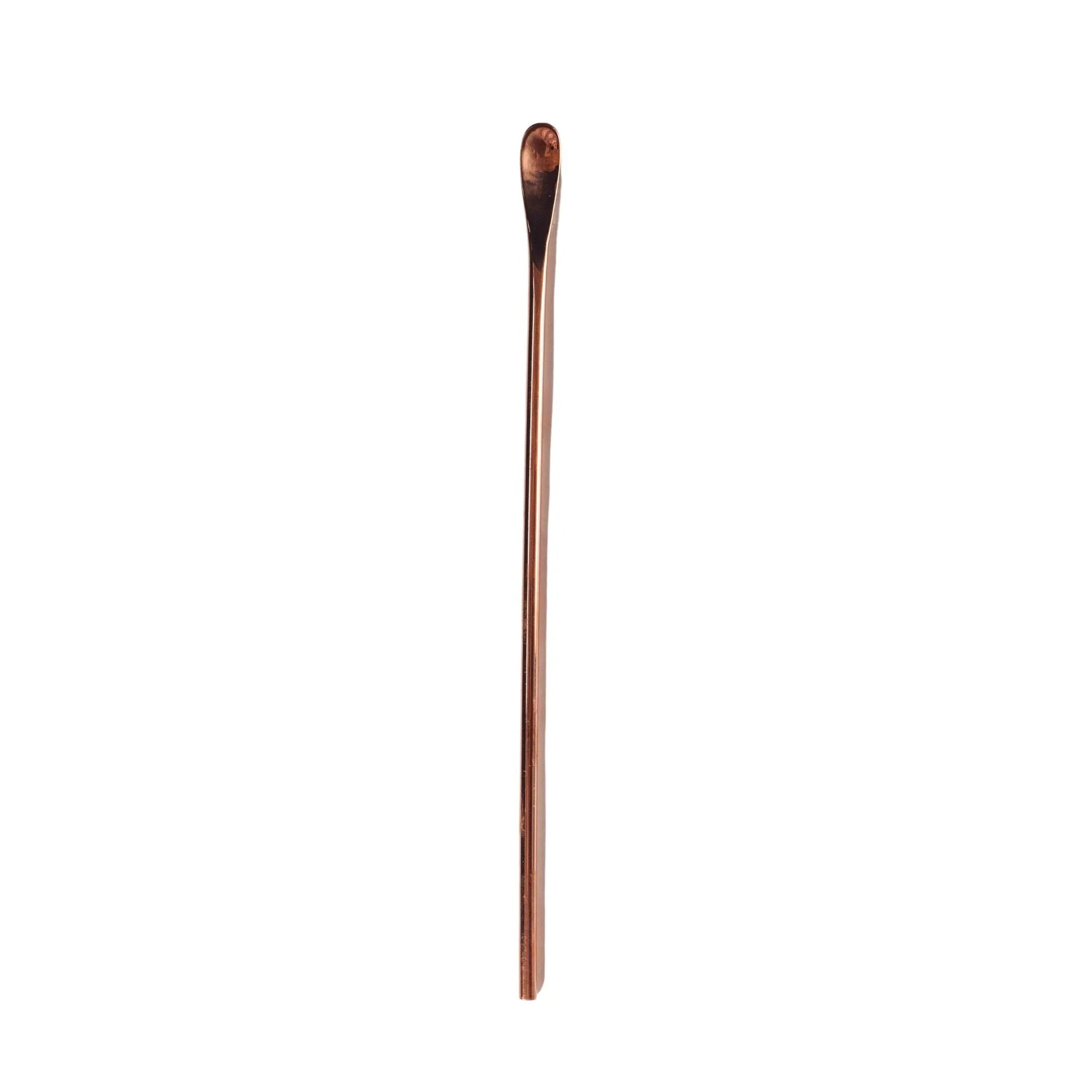 Handcrafted copper bar spoon with a gleaming finish, perfect for stirring cocktails.