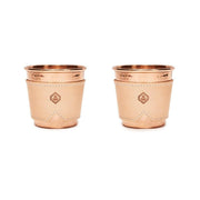 Two 12 oz hammered copper mugs with natural leather sleeves featuring an anchor logo.