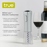 Sleek silver electric wine opener with a transparent base, nonstick worm, and integrated foil cutter next to a wine bottle.