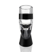 Clear plastic True Aereo wine aerator with a black band and stand, enhancing flavor.