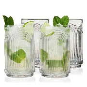 Set of 4 clear crystal highball glasses with repeating 3D arched Art Deco design, two filled with mojitos.
