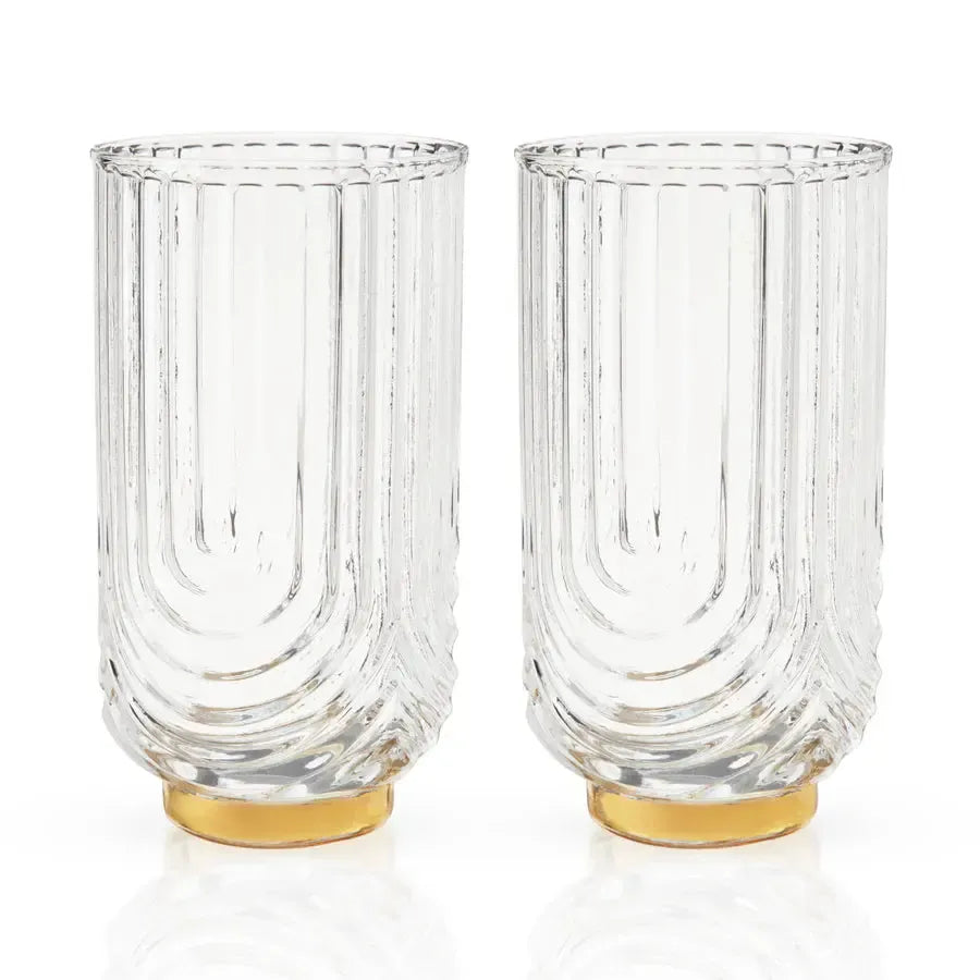 Set of 2 clear lead-free crystal highball glasses with gold electroplated bases and vertical ribbed Gatsby design.