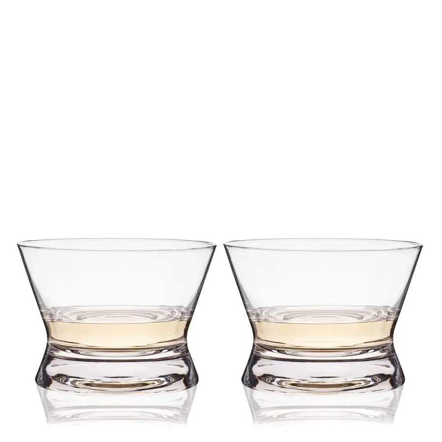 Two clear, lead-free crystal tequila tasting glasses with flared lips and wide bowls, each holding amber liquid.
